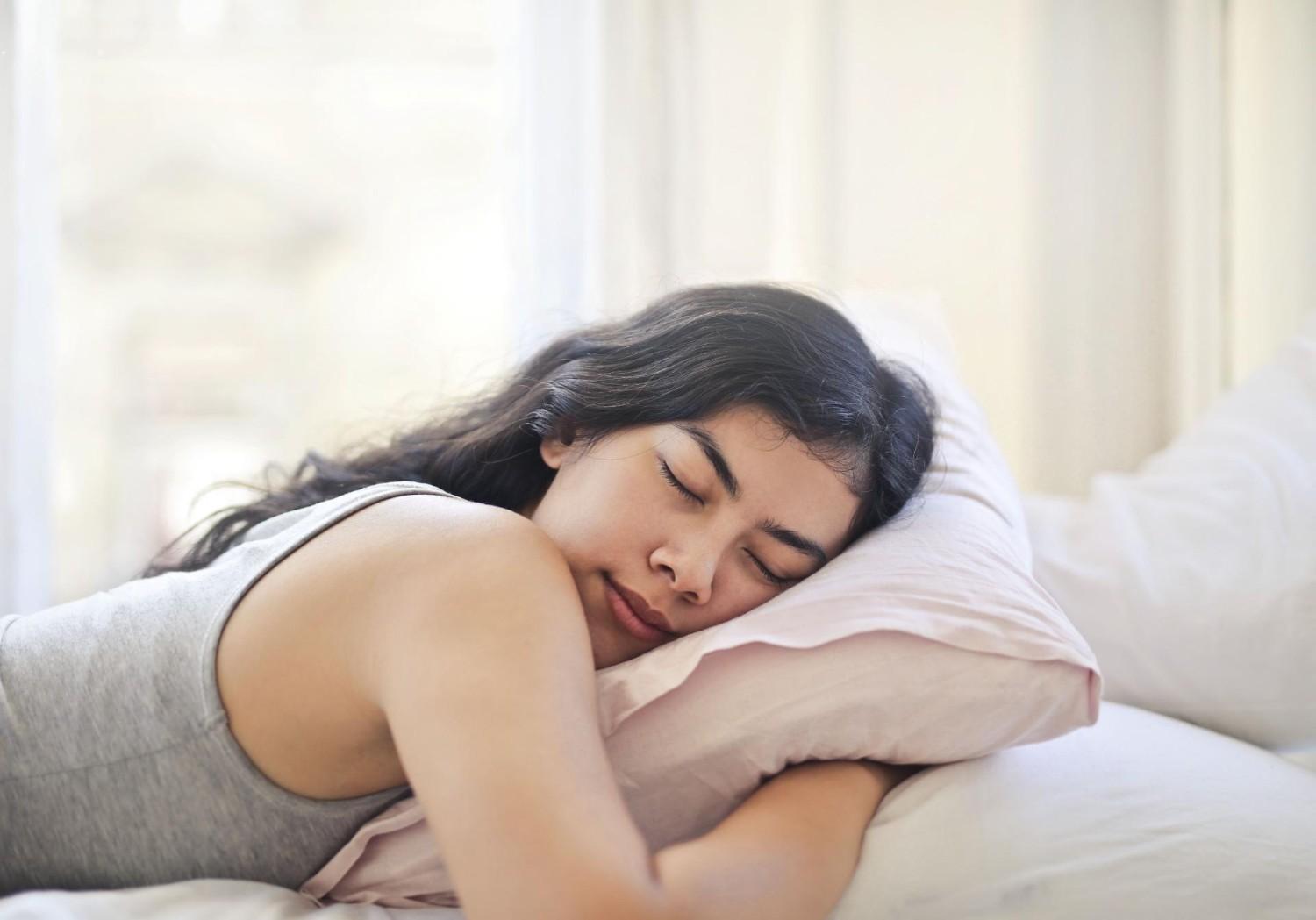 Woman peacefully sleeping on pillow