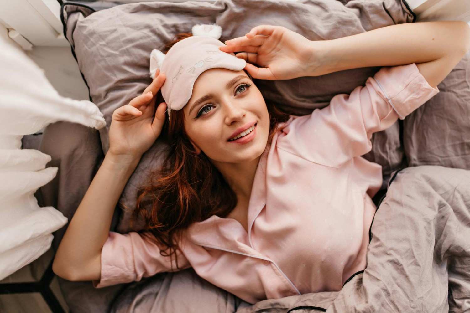 Woman with sleep mask smiling
