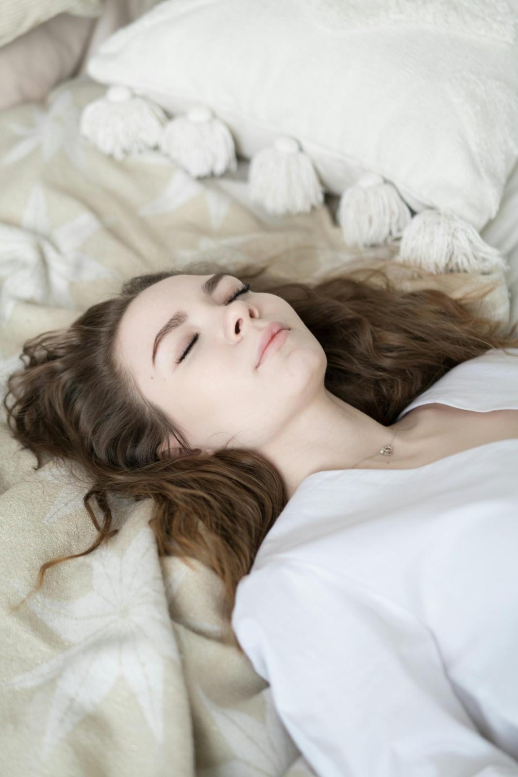 Young woman resting on bed